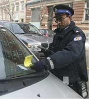 Photo of a traffic enforcement officer placing a ticket on someone car windshield.
